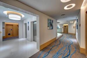 a hallway in a hospital with a painting on the wall at Al Khoory Inn Bur Dubai in Dubai