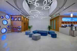 a lobby with blue seating and a chandelier at Al Khoory Inn Bur Dubai in Dubai