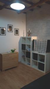 a living room with a book shelf and a television at Casa Vacanze Trapani Vico compagni in Trapani