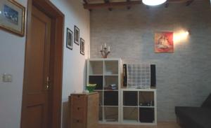 a room with a book shelf and a wall at Casa Vacanze Trapani Vico compagni in Trapani