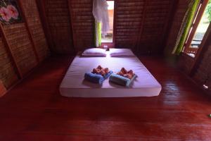 2 camas con almohadas en una habitación en Rakkan Resort en Ko Phra Thong
