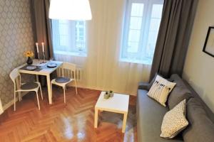 a living room with a couch and a table at River Side Apartment Old Town in Gdańsk