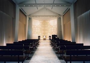 an aisle in a church with chairs and a large window at Hotel Terrace the Garden Mito in Mito