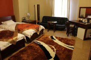 Postel nebo postele na pokoji v ubytování Kanaan Group Hotel