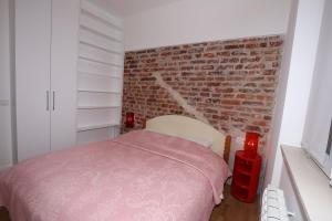 A bed or beds in a room at Largo Apartment