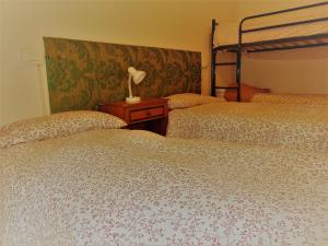 a bedroom with two beds and a lamp on a table at Mi.Ma's dream in Milano Marittima