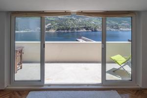 a room with a window with a view of the water at Apartment Matijas in Trstenik
