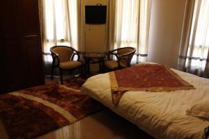 Postel nebo postele na pokoji v ubytování Kanaan Group Hotel