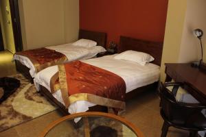 Postel nebo postele na pokoji v ubytování Kanaan Group Hotel