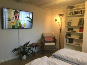 a bedroom with a tv hanging on the wall at Casa Aurora in Aalborg