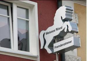 ein Straßenschild an der Seite eines Gebäudes in der Unterkunft Weisses Rössl in Pfreimd