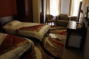 Postel nebo postele na pokoji v ubytování Kanaan Group Hotel
