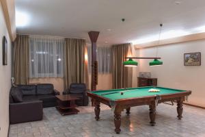 a living room with a pool table in it at Hotel Premiera in Tula