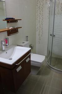 a bathroom with a toilet and a sink and a shower at Kanaan Group Hotel in Baalbeck