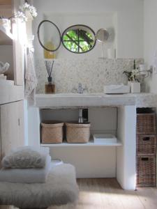 a bathroom with a sink and a mirror at La chambre blanche in Heerlen
