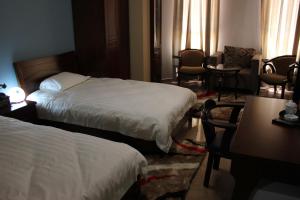Postel nebo postele na pokoji v ubytování Kanaan Group Hotel