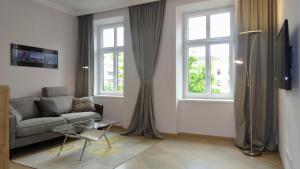 ウィーンにあるSonnberg Design Apartmentのリビングルーム(ソファ、窓2つ付)