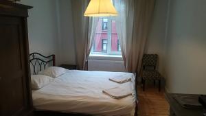 a bedroom with a bed with a lamp and a window at Varnu Apartment in Rīga