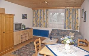 a living room with a couch and a table at Pension Montana in Wagrain