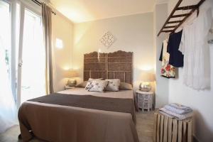 a bedroom with a large bed and a window at Dimore di Mare in San Pietro Vernotico