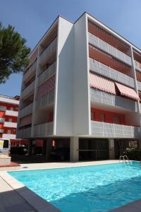 ビビオーネにあるGabbiano - Appartamentiのアパートメントの建物の正面にスイミングプールがあります。