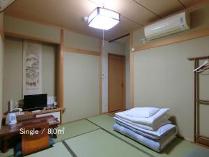 Postel nebo postele na pokoji v ubytování Ryokan Kyoraku