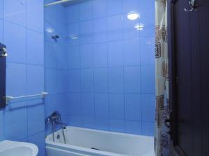 a blue bathroom with a tub and a toilet at Apartment on St. Nikoloz Baratashvili 1 in Batumi +43 photos