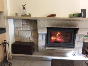 a living room with a fireplace with a fire at Agroturismo Itxaspe in Orio