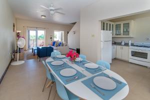 a dining room and kitchen with a table and chairs at Family Complex beside Beach w/Pool Montego Bay #2 in Montego Bay