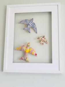 a picture of four starfish in a white frame at Near Beach Apartment in Póvoa de Varzim