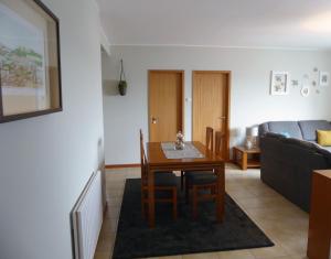 a living room with a table and a couch at Near Beach Apartment in Póvoa de Varzim