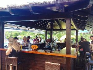 a group of people sitting at a bar at Egrypos Hotel in Petrití