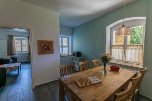 a dining room and living room with a wooden table at Ferienwohnungen Endler in Bad Schandau