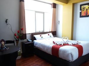 Postel nebo postele na pokoji v ubytování Pumas Cusco Hotel