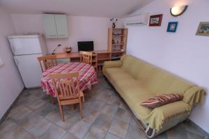 a living room with a couch and a table at Apartments Mama in Rogoznica