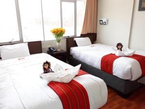 Postel nebo postele na pokoji v ubytování Pumas Cusco Hotel
