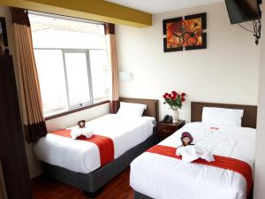 Voodi või voodid majutusasutuse Pumas Cusco Hotel toas