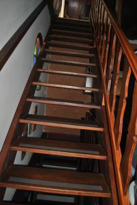 Un escalier avec des marches en bois et un vitrail dans l'établissement Hostel da Montanha, à Campos do Jordão