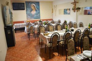 a group of tables and chairs in a room at Pansion Modana Medjugorje in Međugorje