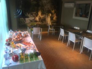 a table with food and drinks on it in a room at La Rocca Guest House & Spa in Montefalco