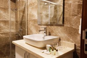 un baño con lavabo y ducha en The White Orient Hotel, en Estambul 30 fotos más