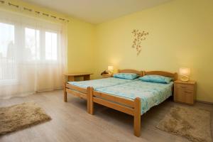 a bedroom with a bed and a large window at Apartment Ivica in Fažana