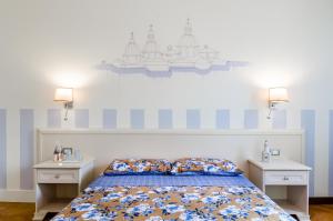 Schlafzimmer mit einem Bett mit blauen und weißen Streifen in der Unterkunft Appartamento Alloro in Treviso