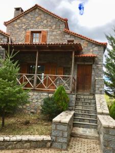 an old stone house with a front door and stairs at Anna Vytina in Vitina