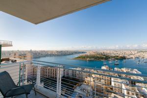 a balcony with a view of a river and buildings at Seafront Apartment Sliema in Sliema