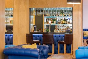 a bar with blue leather chairs and a blue bar at Carlton Hotel in Ilfracombe