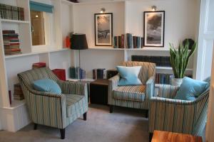 two chairs with blue pillows in a living room at Carlton Hotel in Ilfracombe