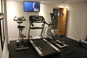 a gym with two exercise bikes and a flat screen tv at Carlton Hotel in Ilfracombe