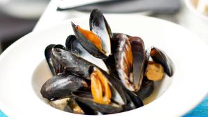 a white bowl filled with mussels on a table at Carlton Hotel in Ilfracombe
