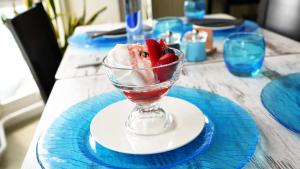 a bowl of ice cream and strawberries on a table at Carlton Hotel in Ilfracombe